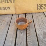 Brown sandstone cup with white spots