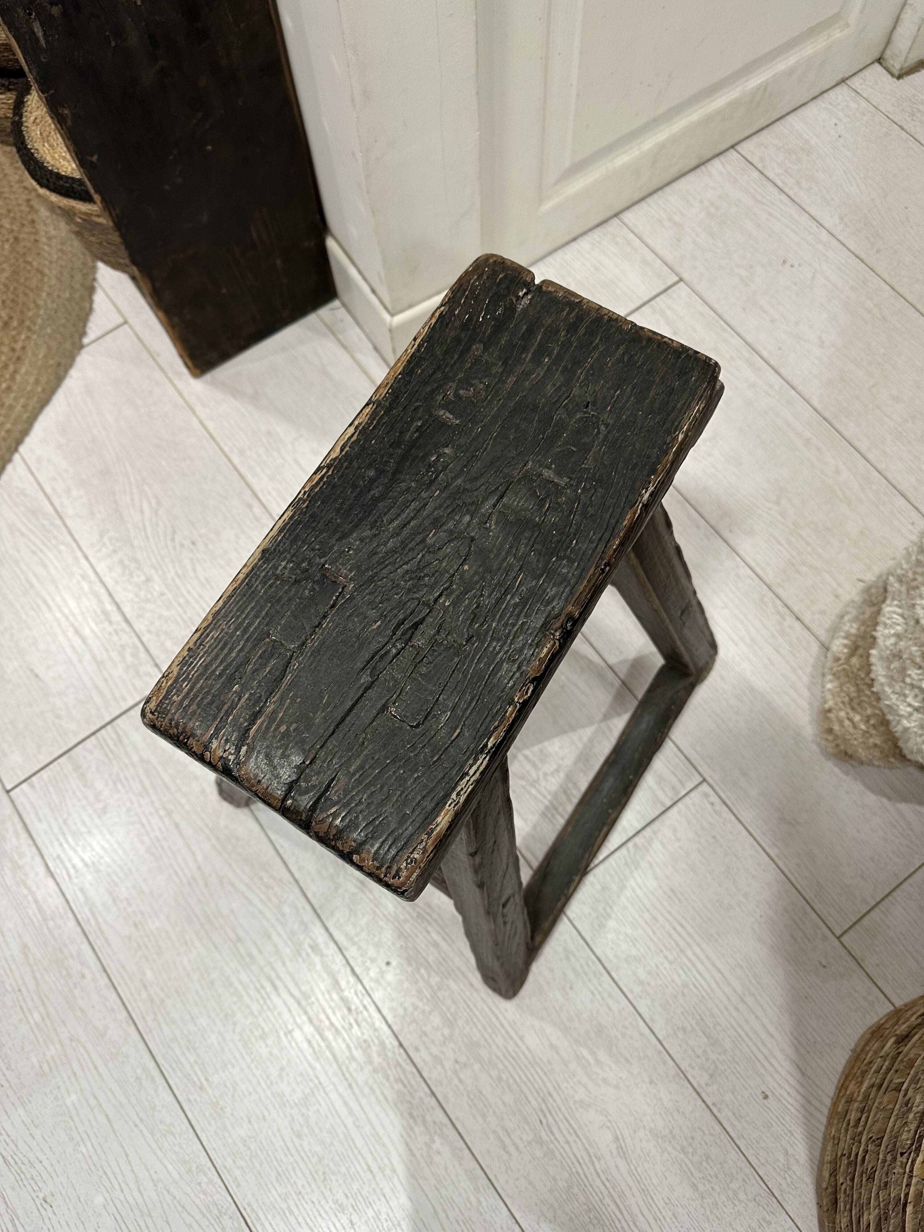 Rectangular stool in raw black elm.