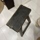 Rectangular stool in raw black elm.