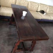 19th-century brown walnut dining table with sculpted trestle legs.