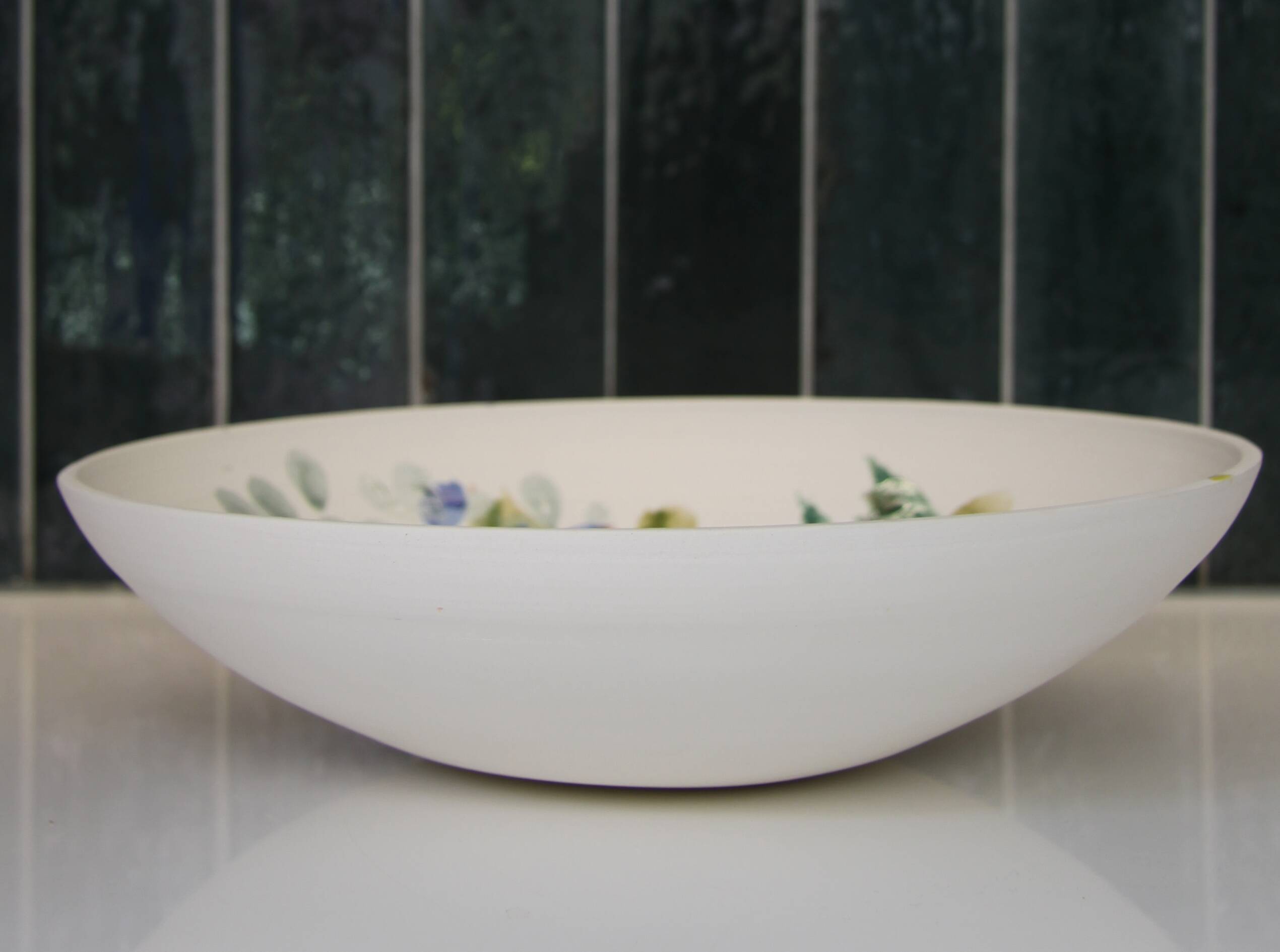 Decorated white earthenware fruit bowl