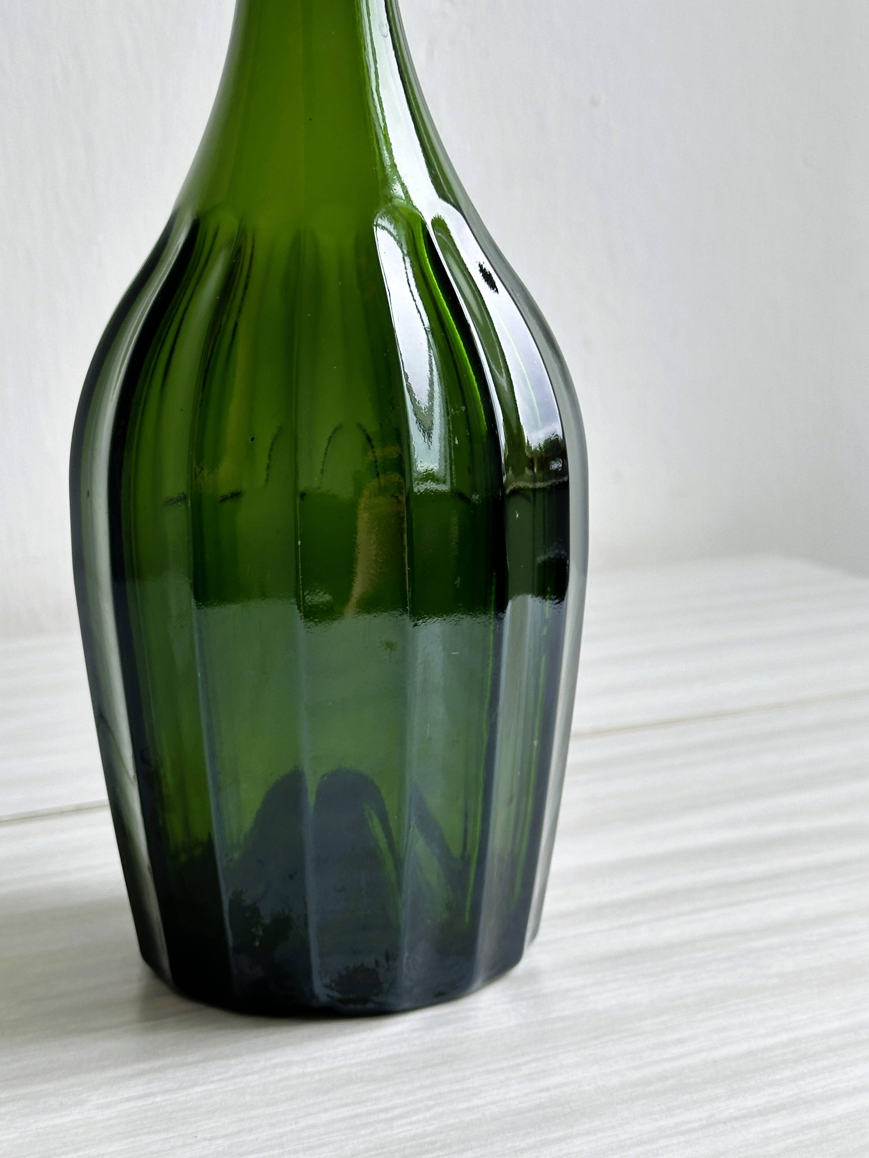 Translucent green glass bottle, classic design.