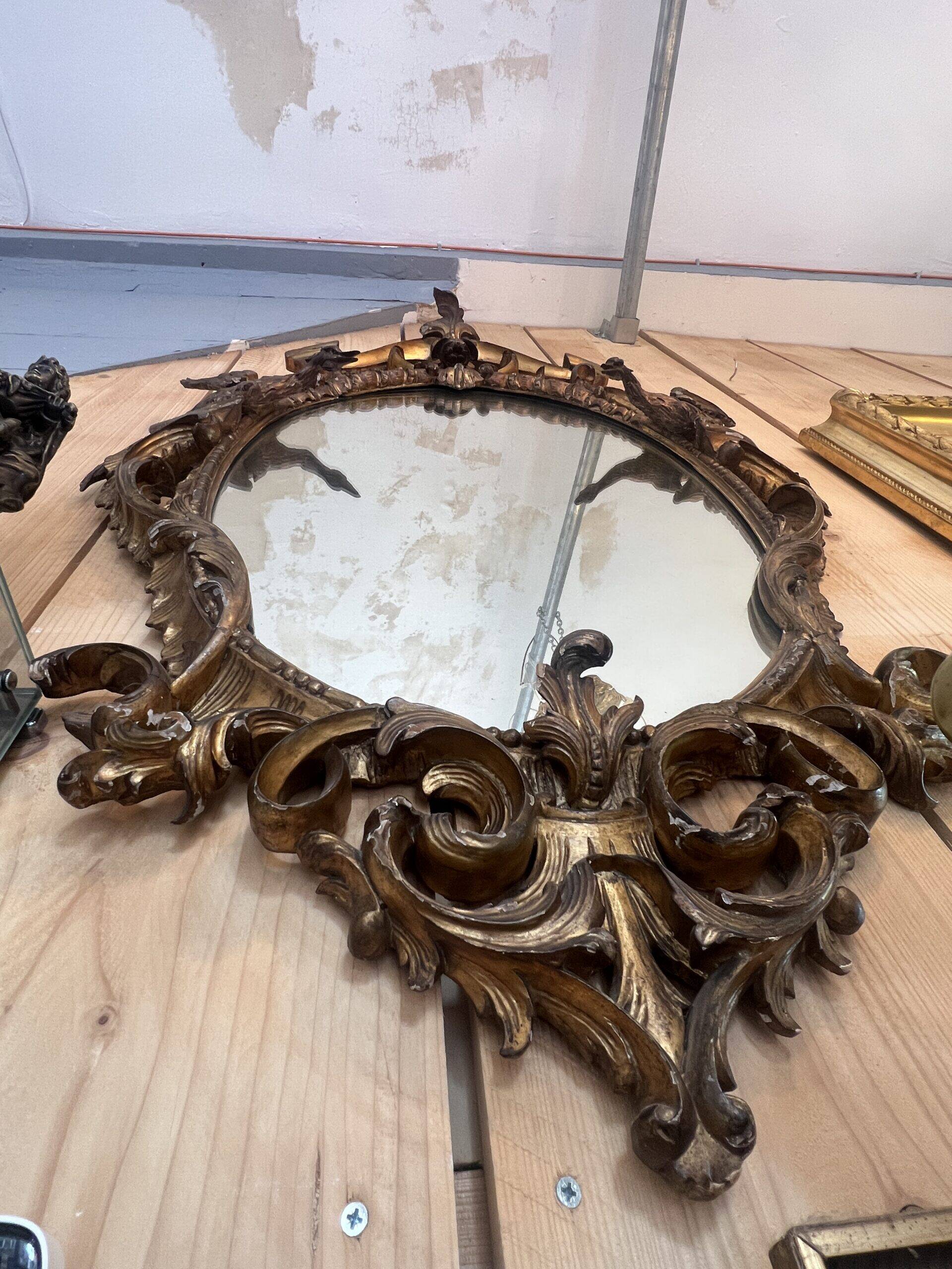 Large gilded wooden mirror, richly carved with winged dragons, 19th century