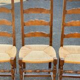 4 or 5 solid wood chairs with light oak straw and high backs