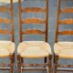 4 or 5 solid wood chairs with light oak straw and high backs