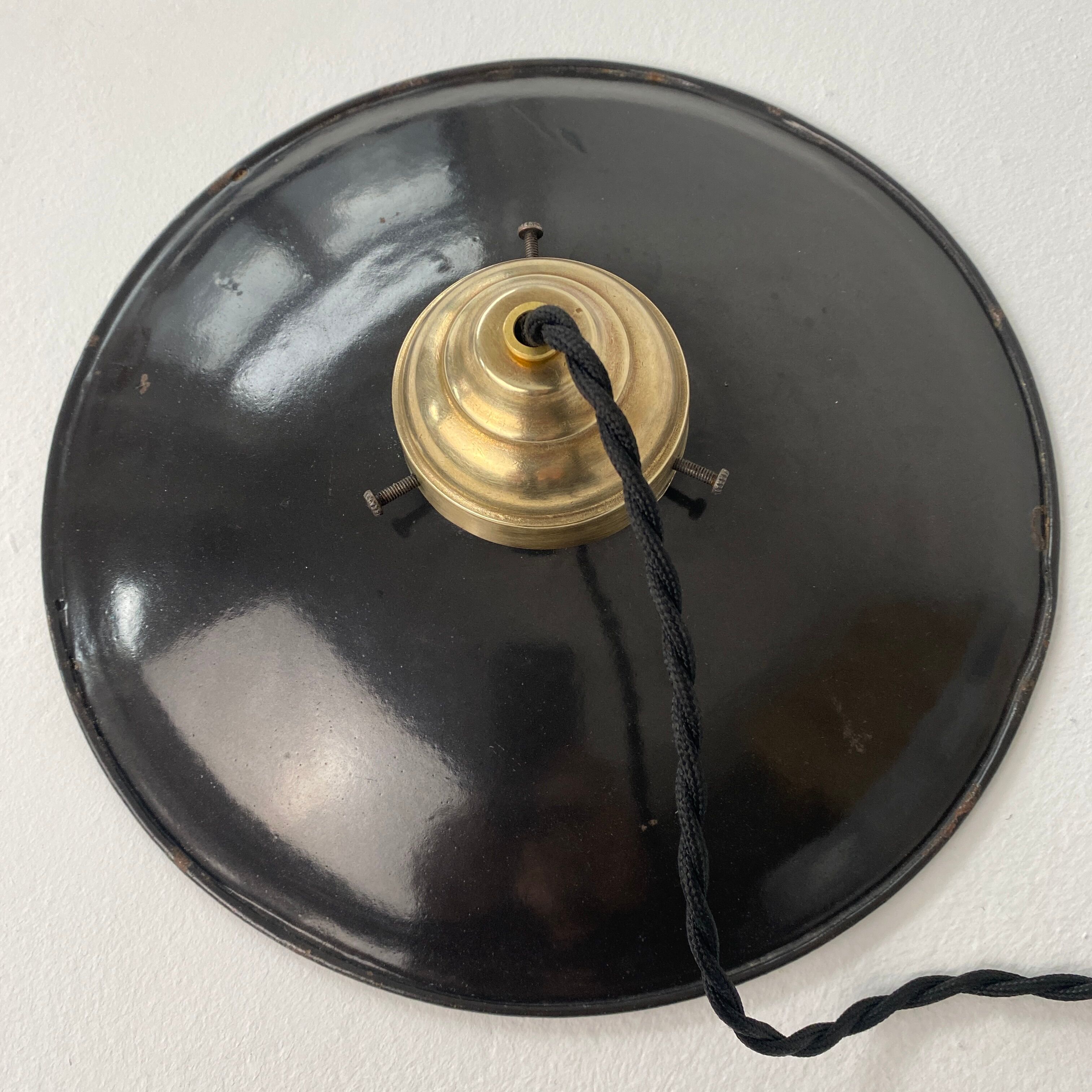 Old black enamelled industrial suspension