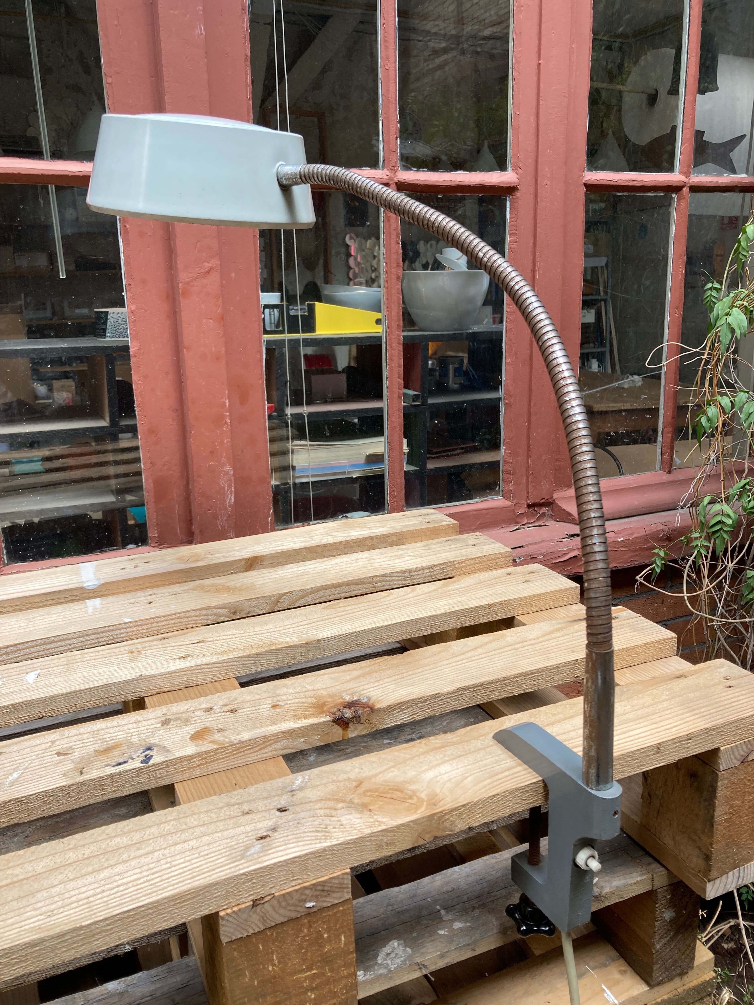 Workshop lamp on ringed metal hose