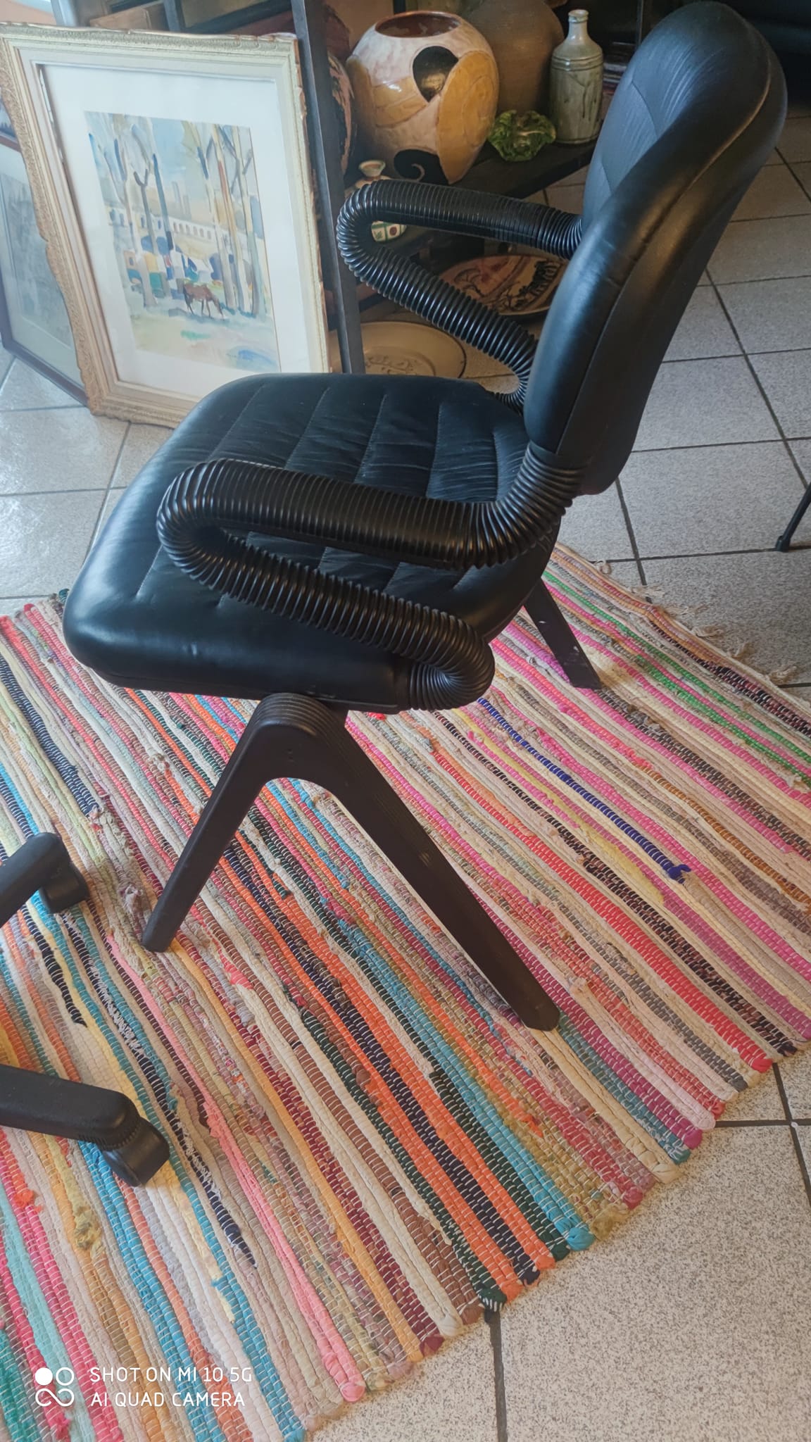 Two black leather armchairs