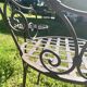 Old wrought iron table and its armchairs and chairs for outdoor use.