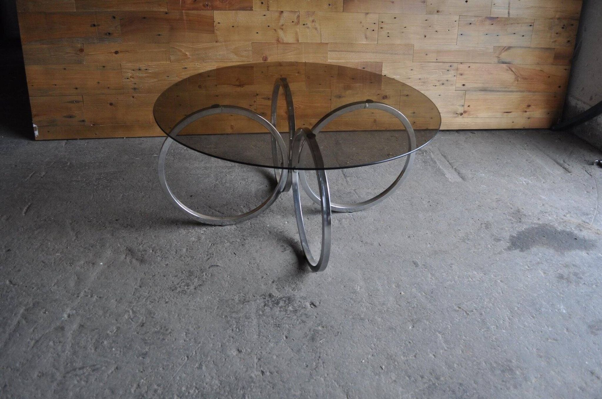Vintage tubular coffee table in chrome with a transparent glass top, Mid-Century style 1960s.