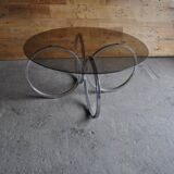Vintage tubular coffee table in chrome with a transparent glass top, Mid-Century style 1960s.