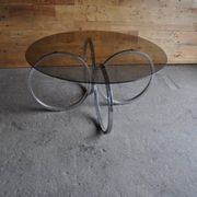 Vintage tubular coffee table in chrome with a transparent glass top, Mid-Century style 1960s.