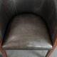 Set of two cowhide and wooden tub chairs with a sturdy colour scheme