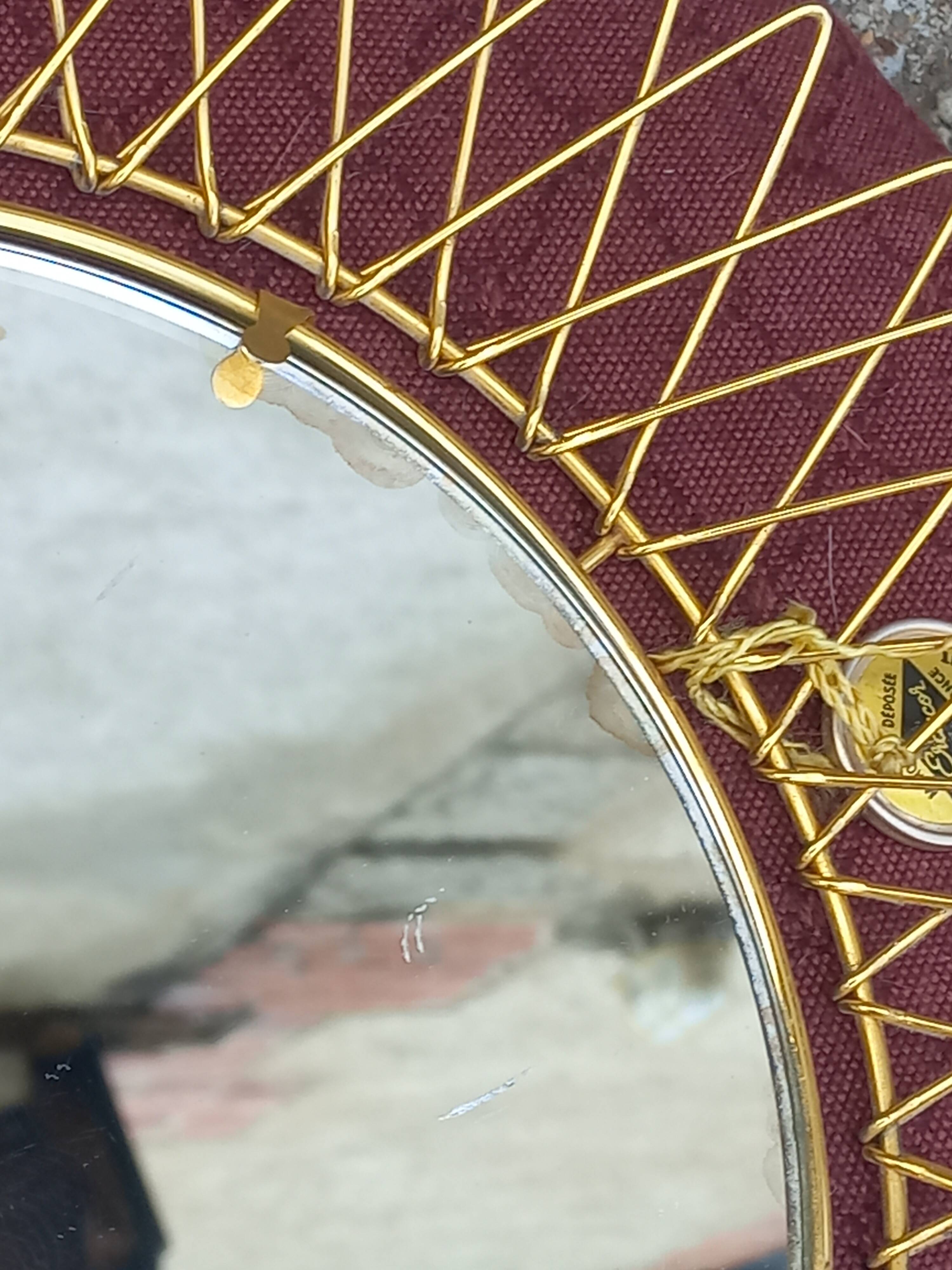 Vintage 1950s sun mirror in gold metal.