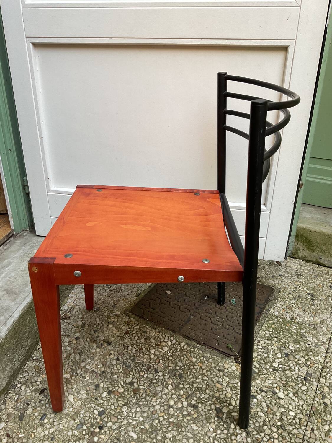 Chair with wooden seat and rare steel back