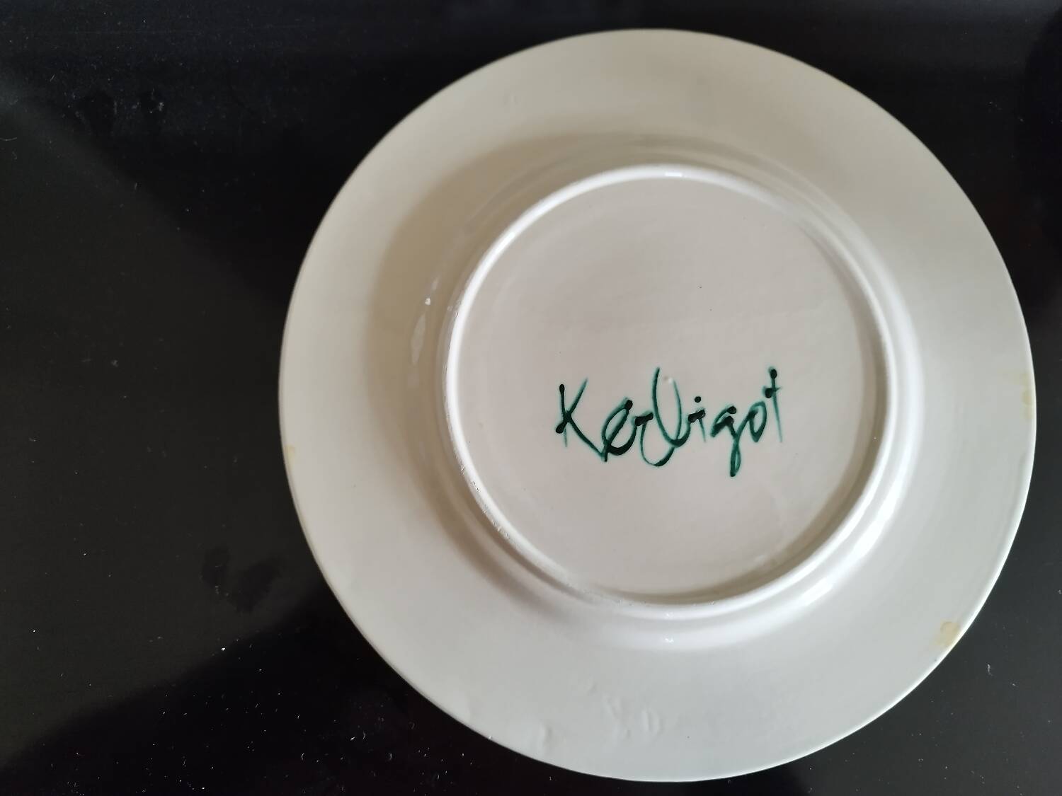 Plate decorated with yellow and green flower, signed Kerbigot.