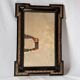 Antique wall mirror in blackened wood and gilded stucco, 19th-century Dutch style.