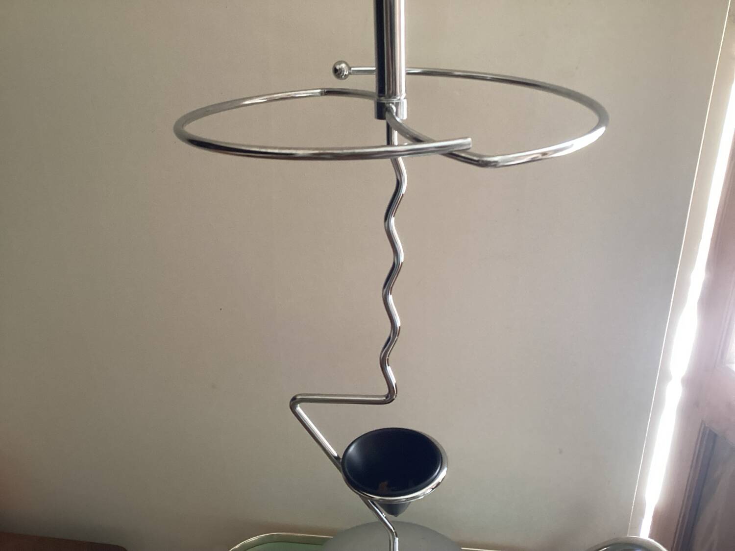 Designer umbrella stand in chrome metal and wood.
