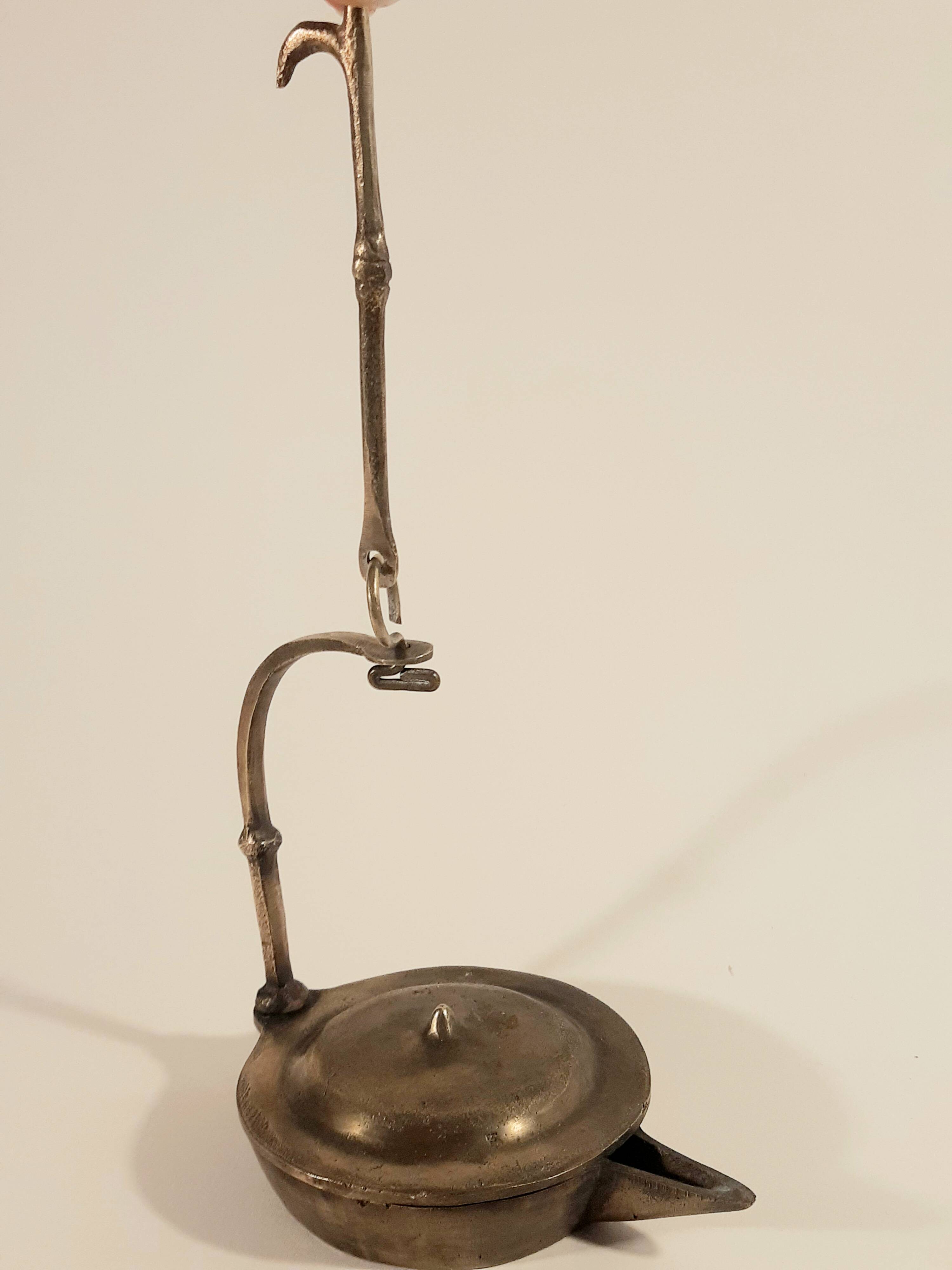 Old oil lamp in golden brass to hang