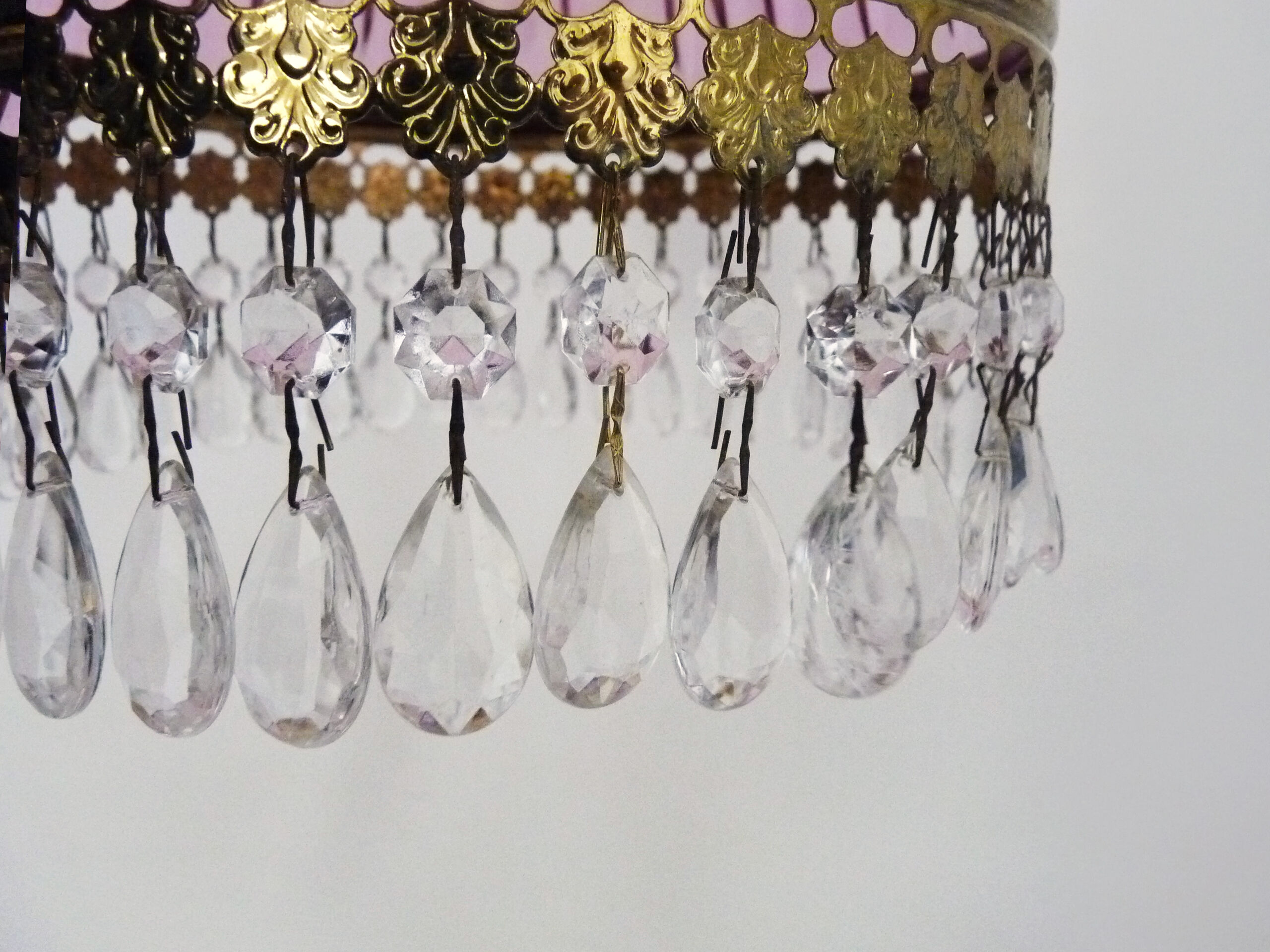 Vintage rose pendant light with pendants and patterned glass globe.
