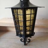 Large hanging lantern in wrought iron and opaque yellow-orange windows