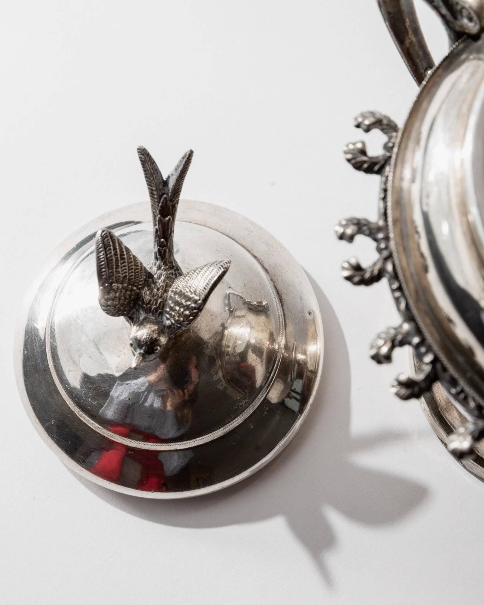 Vintage 1930s silver-plated footed bowl with lid by Warren Rogers New York, featuring a bird motif and ornate details.