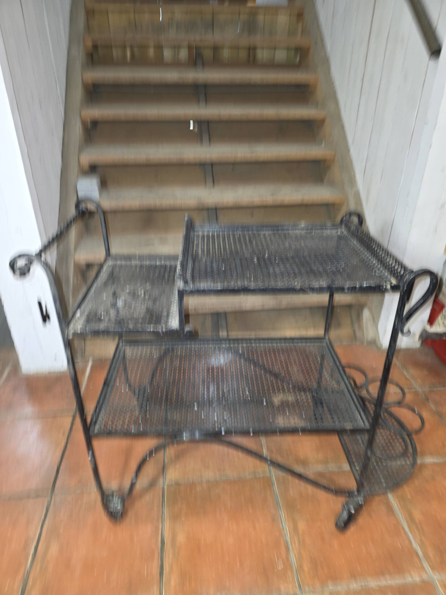Perforated wrought iron rolling dessert trolley