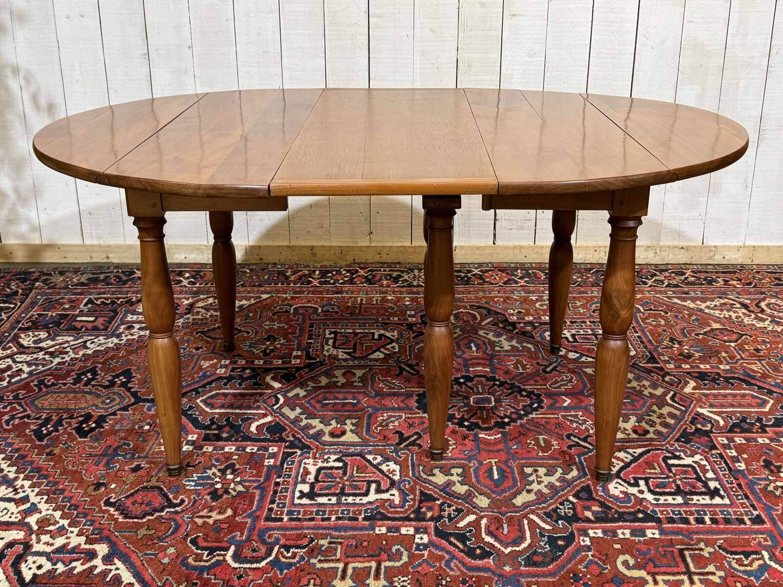 Round cherry wood table, 6 feet, Louis Philippe style with 2 extensions.