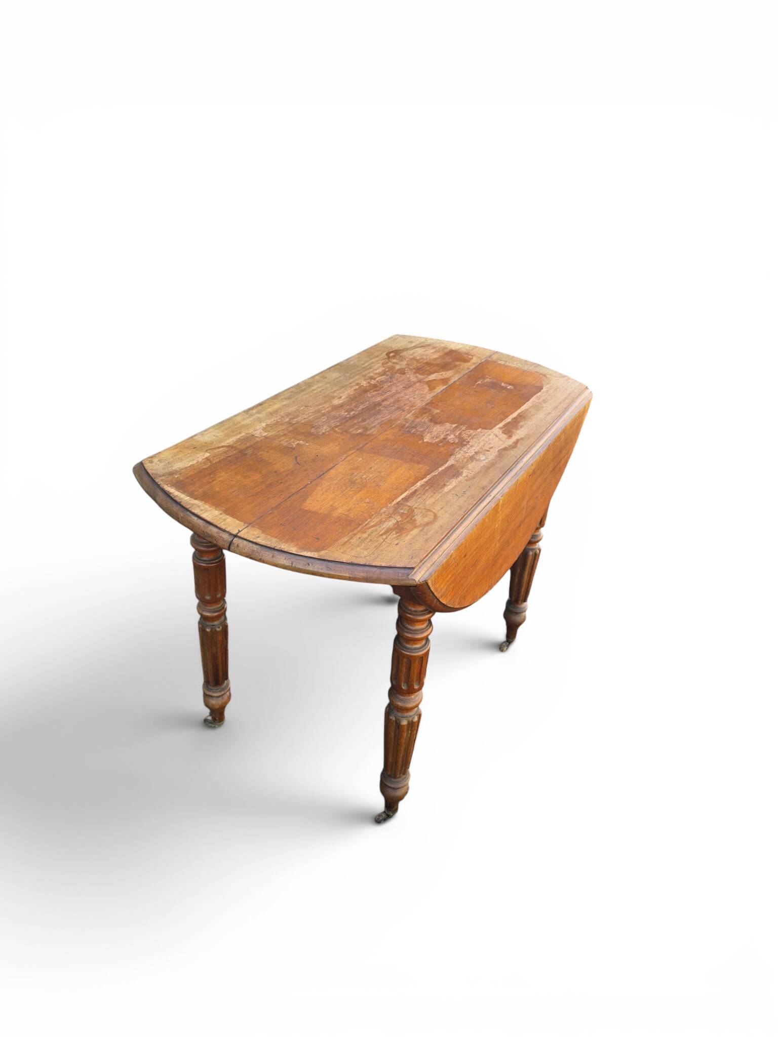 Antique drop-leaf table in wood, with turned legs and castors.