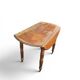 Antique drop-leaf table in wood, with turned legs and castors.