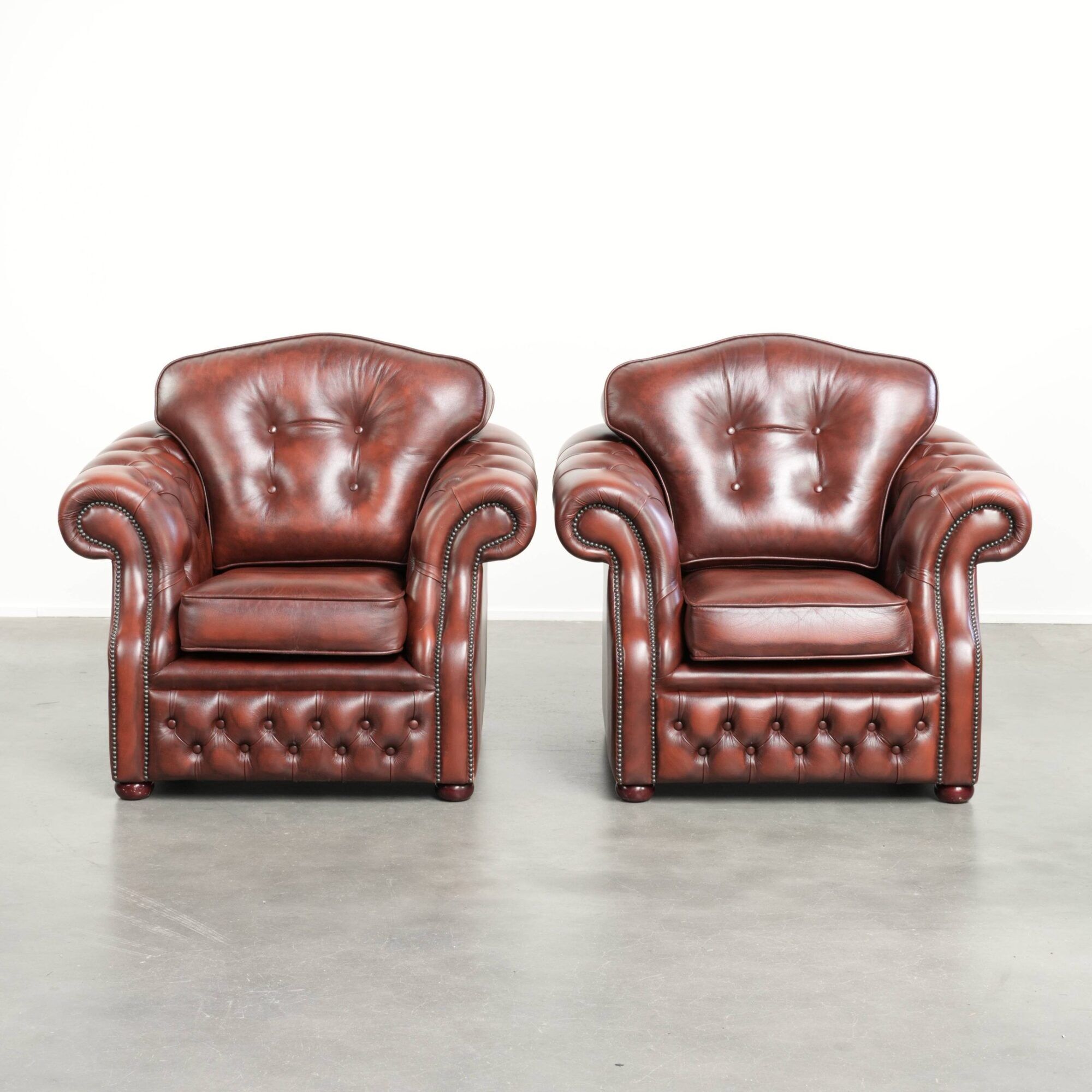 Vintage set of 2 cowhide leather Chesterfield armchairs in a brown colour