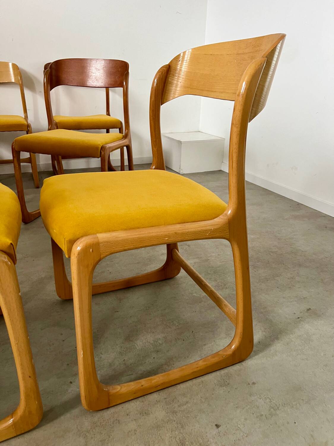 Set of 7 Baumann sled chairs in wood and mustard yellow fabric, 1960s