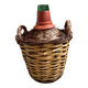 Old glass demijohn with wicker basket.