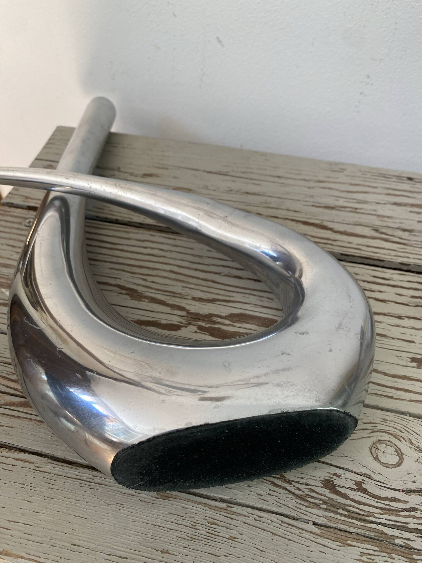 Sculptural vase design in polished aluminium.