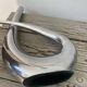 Sculptural vase design in polished aluminium.