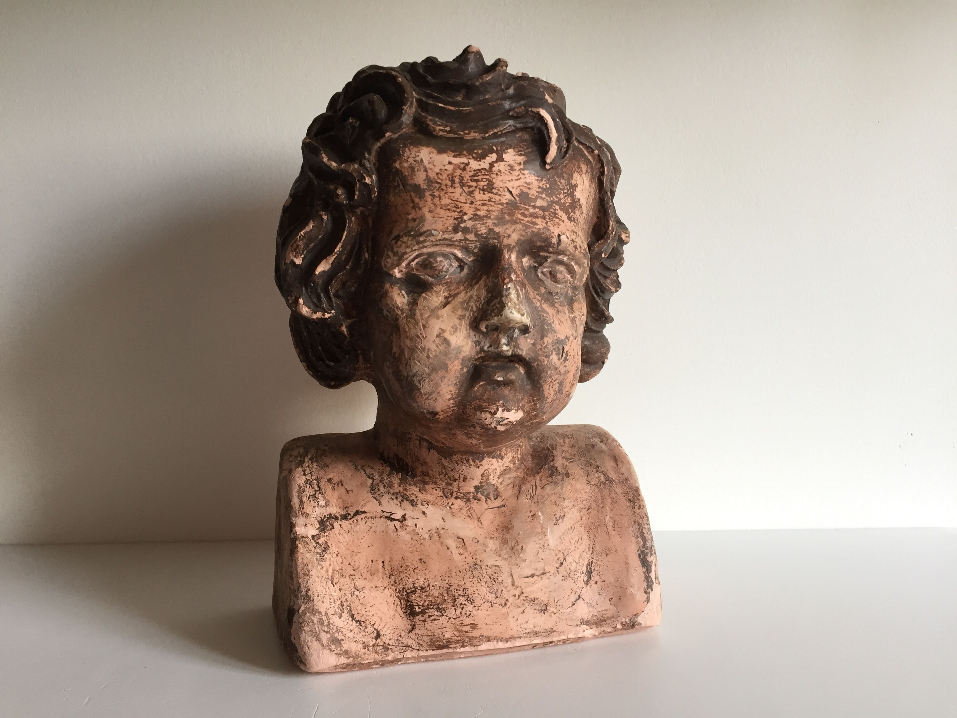 Bust old child in plaster stamped l.j.c.