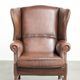 Comfortable cowhide wingback armchair in English style with a timeless look