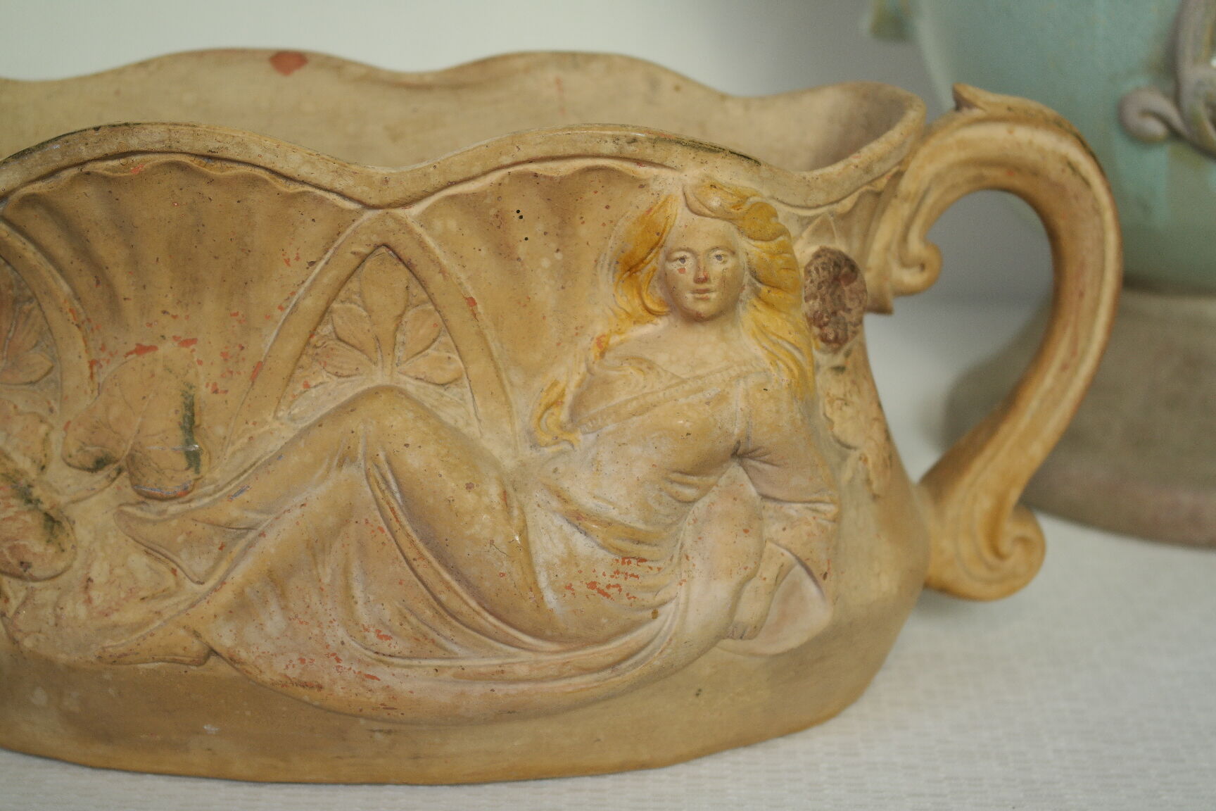 Art Nouveau jardinière with bas-reliefs in terracotta.