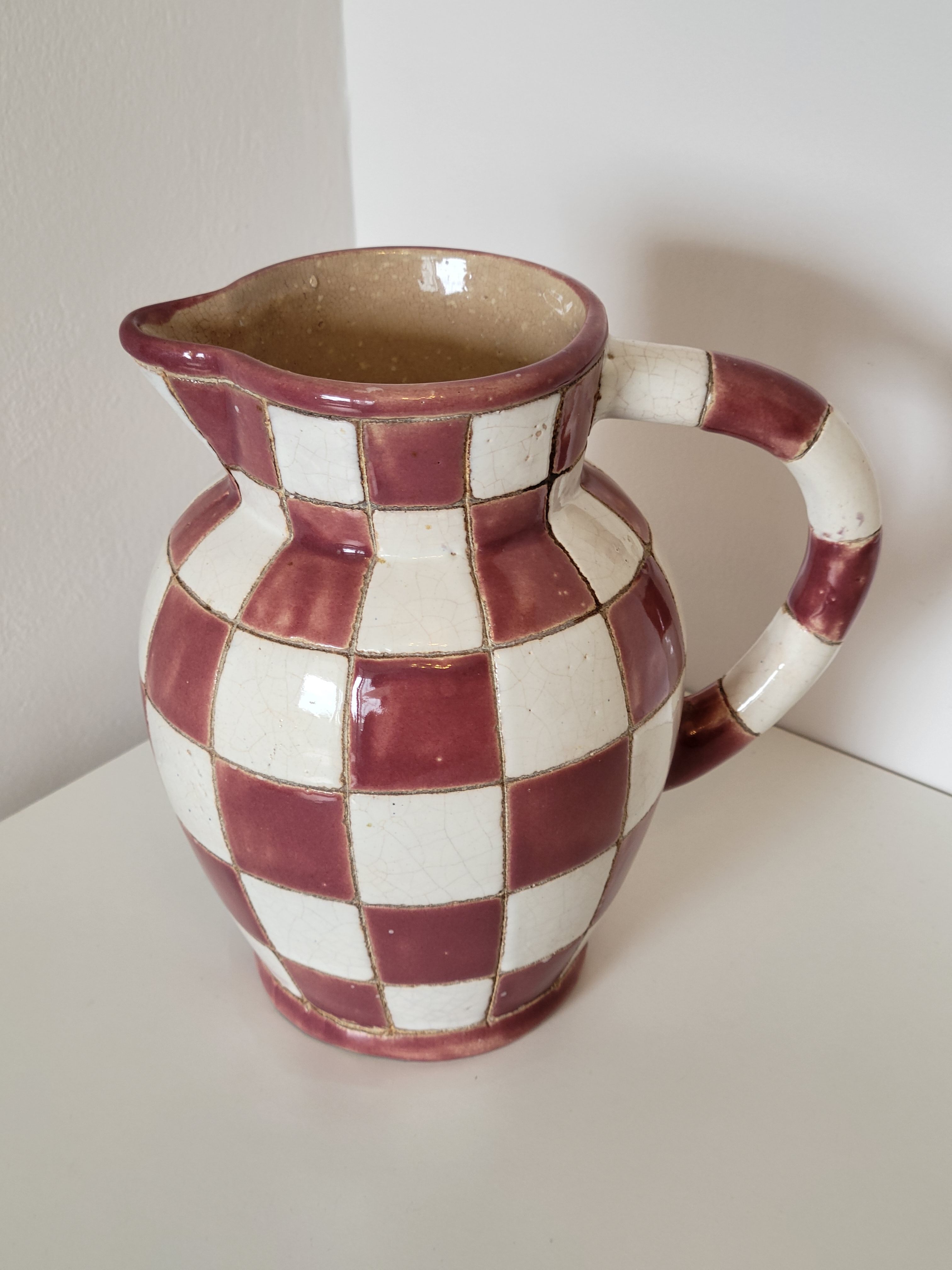 Old ceramic pitcher pattern checkerboard tiles