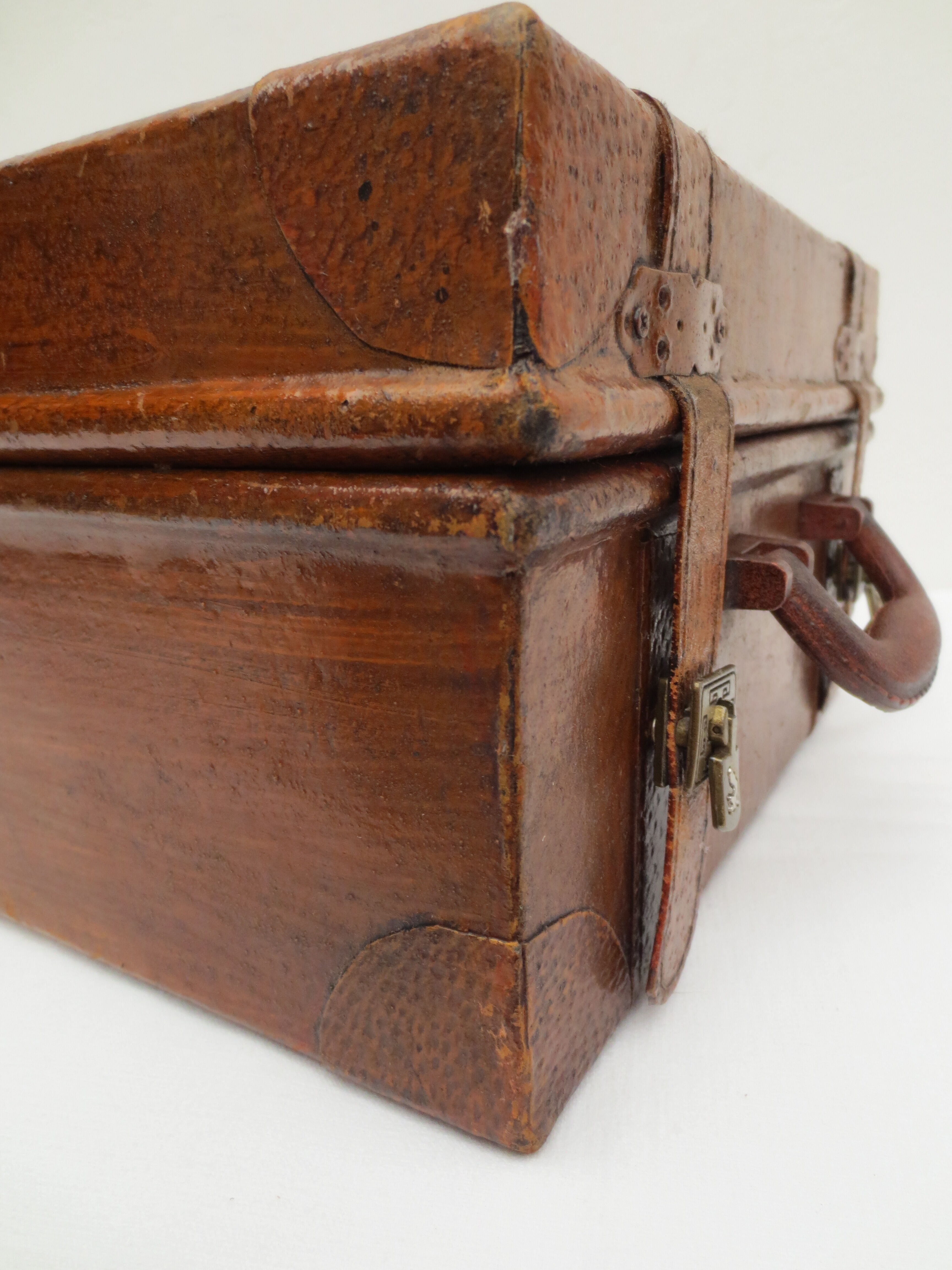Rectangular wooden suitcase covered with leather