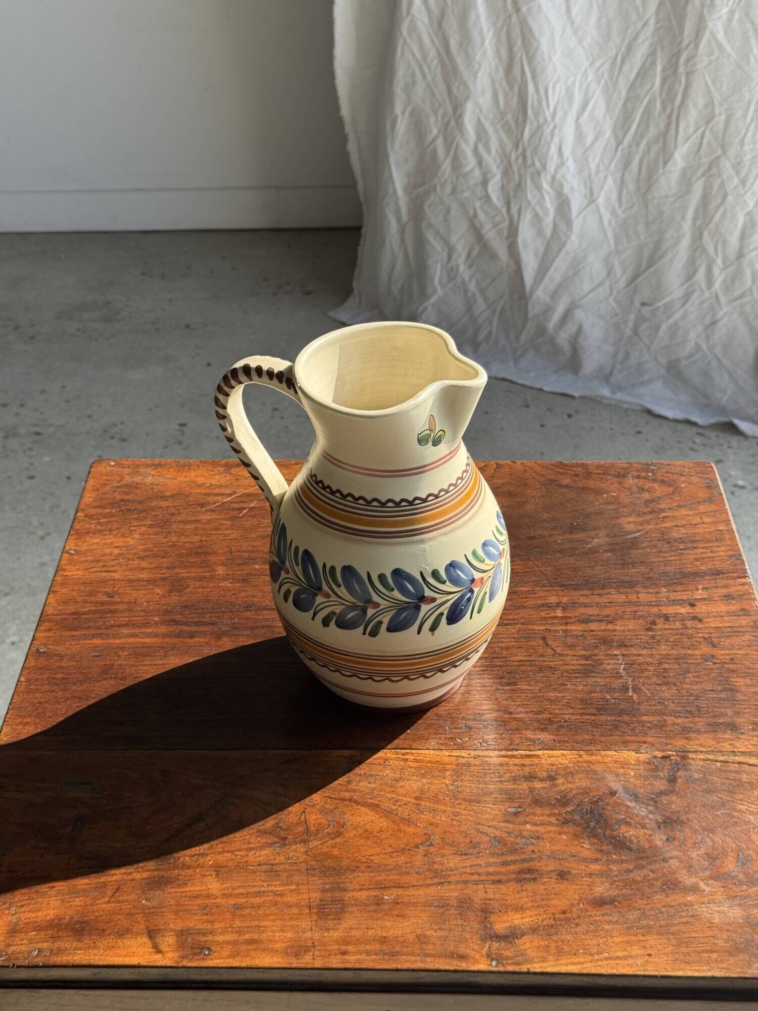 Beige carafe with stylized blue flower friezes