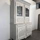 Two-body glass buffet in patinated grey and white oak.