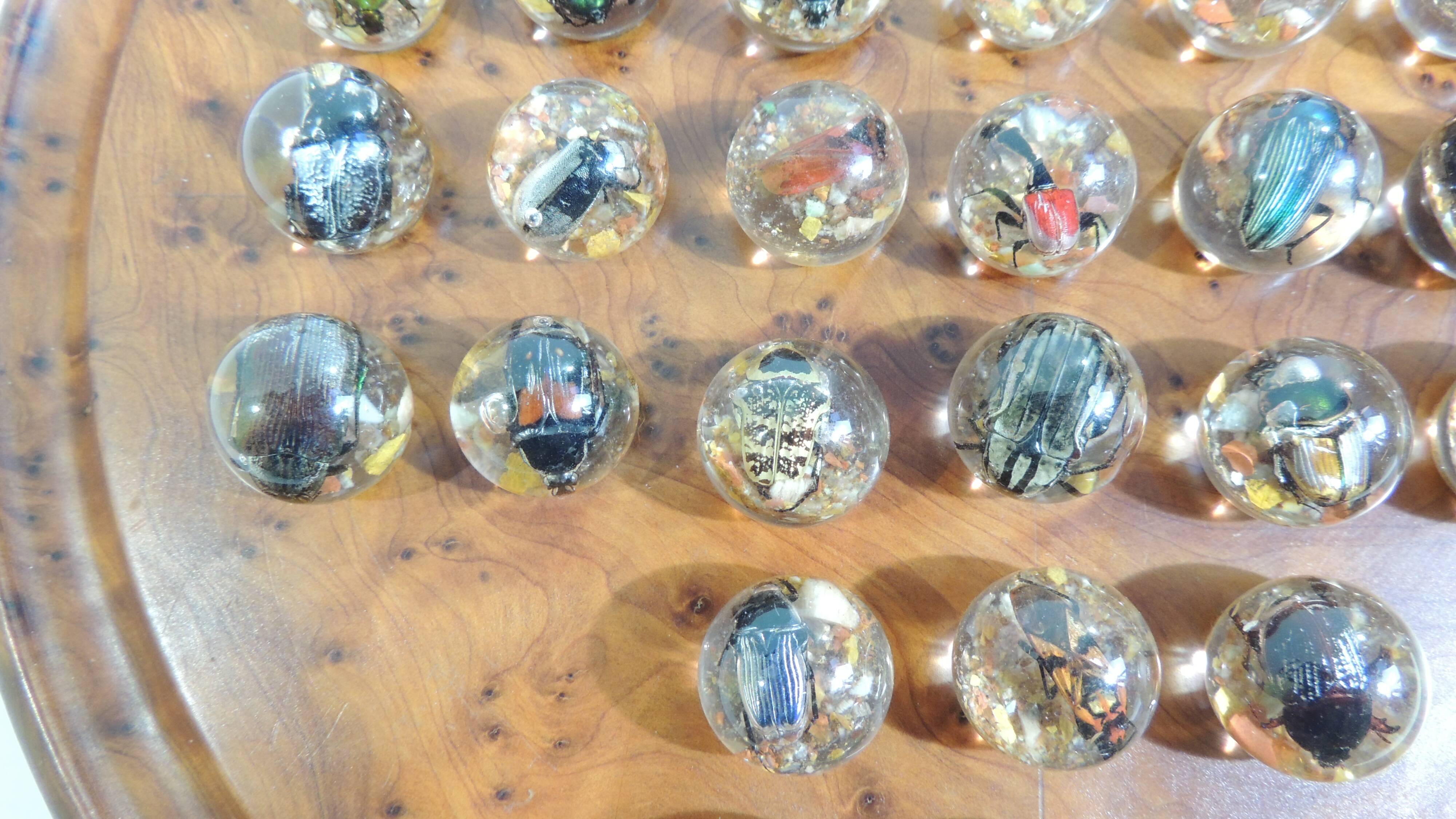 Vintage wooden solitaire game with resin balls and insects – Madaga
