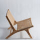 Reclining armchair in natural wood and woven rattan