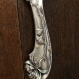 shovel picks up silver table crumbs