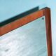 Minimalist Scandinavian mirror in teak with a vintage design.