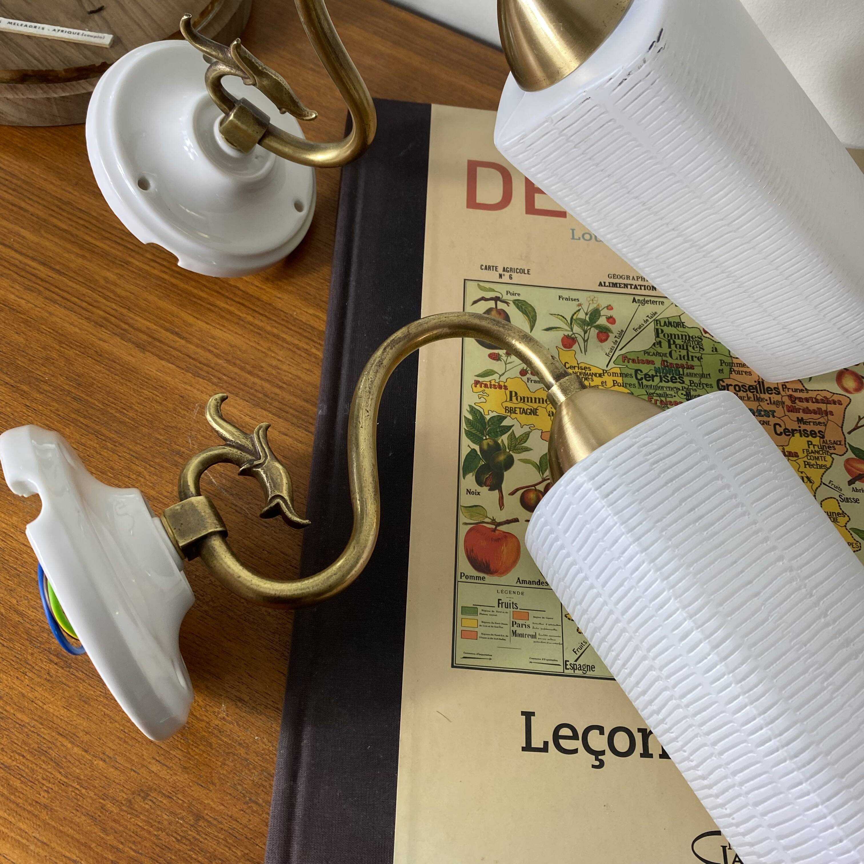 Pair of swan neck wall lights in brass, white glass and porcelain.