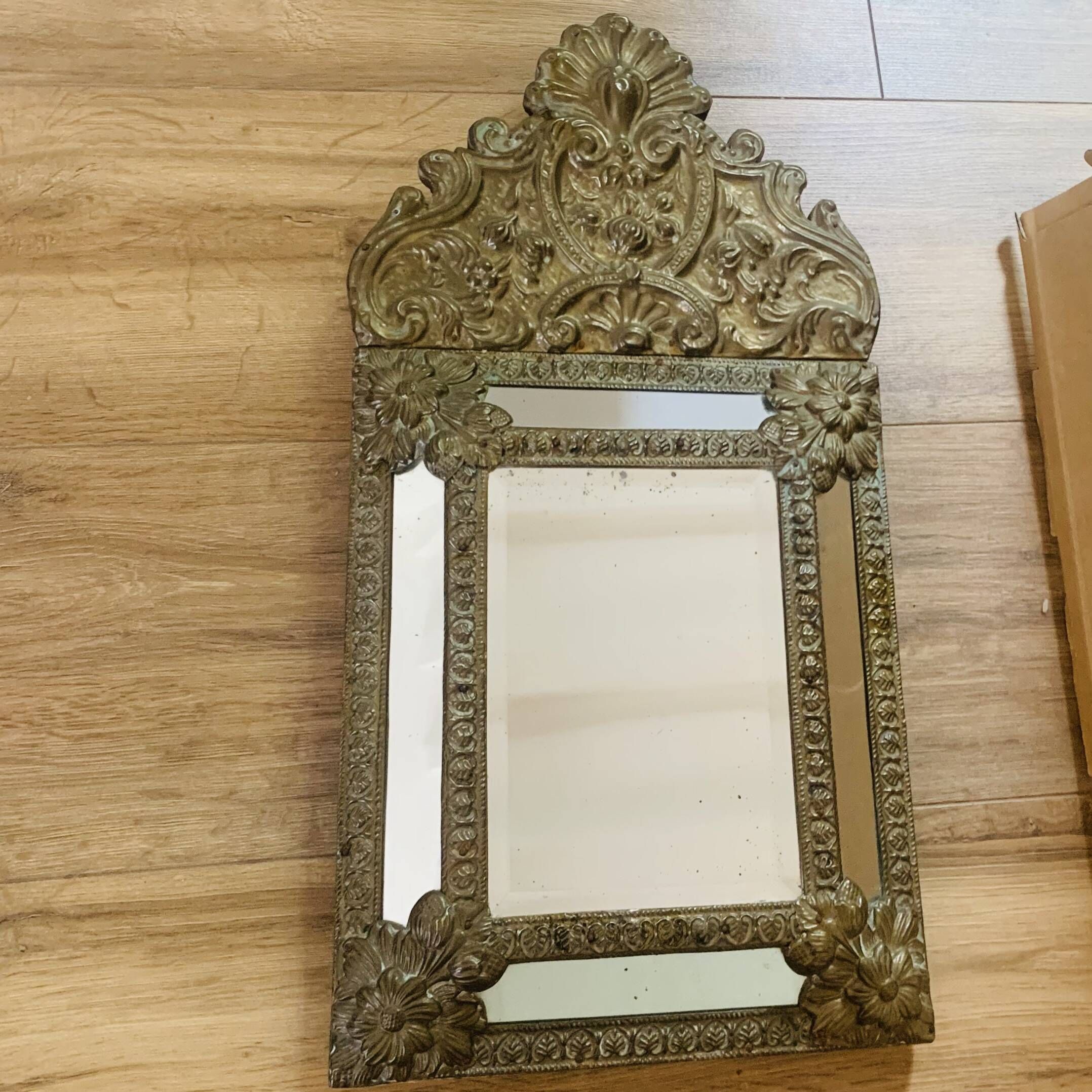 Small mirror with repoussé brass frame.