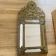 Small mirror with repoussé brass frame.
