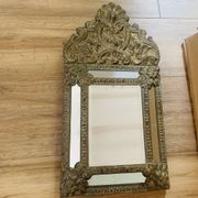Small mirror with repoussé brass frame.